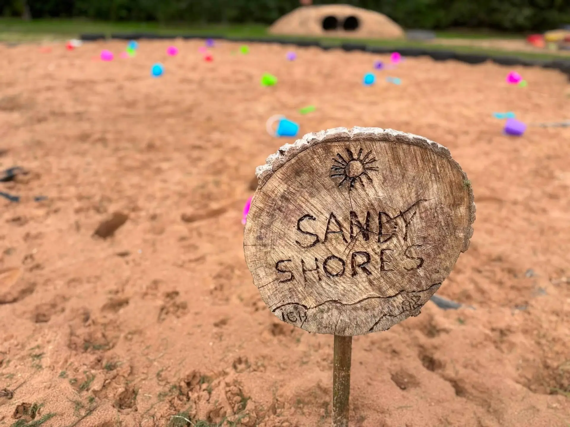 Sandy Shores sand play area with buckets and spades