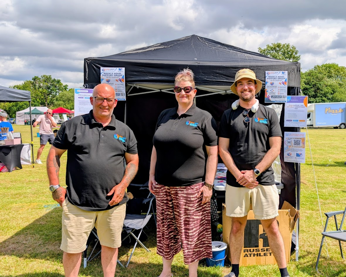 ADHD Unite Network UK team smiling in front of their stall at Altrincham Festival