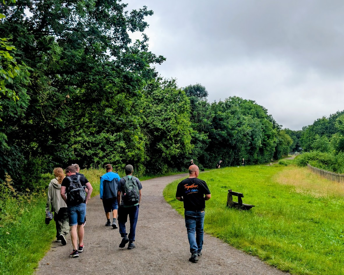 ADHD Unite group walking a tree-lined path at Chorlton Water Park