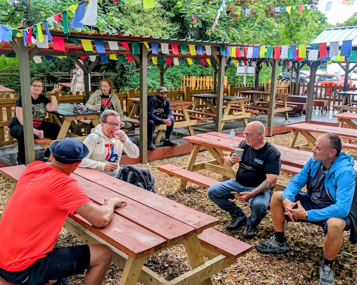 The group enjoying a brew together under colourful bunting after the walk