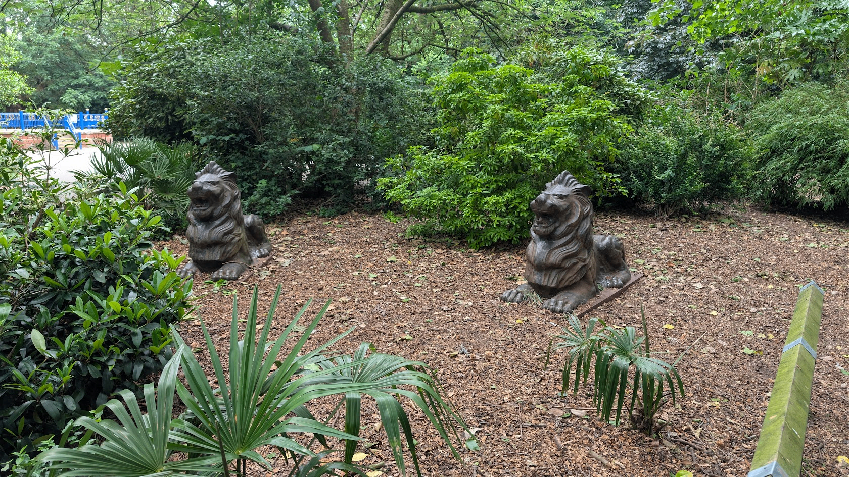 Stone lion statues among the greenery at Worthington Park